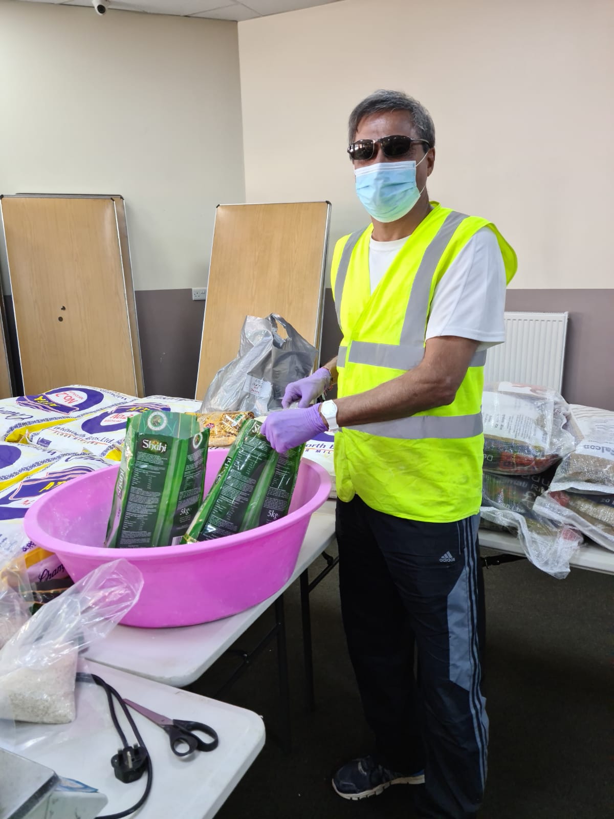 A Volunteers repacking bulk items into small parcels